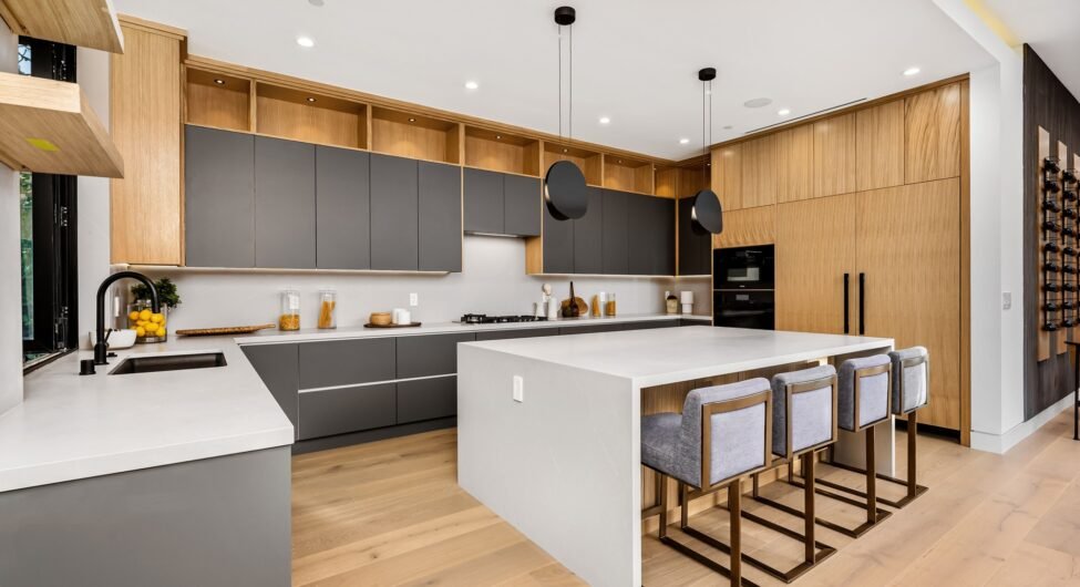 Modern kitchen interior with a large island and sleek cabinetry.