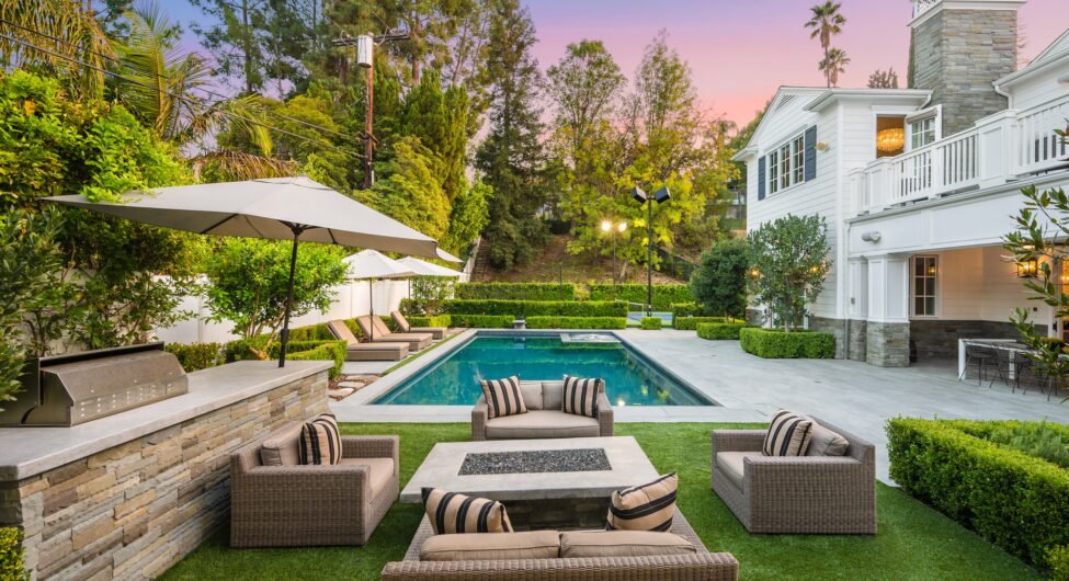 Poolside patio with outdoor dining table in a new construction home in Encino, California